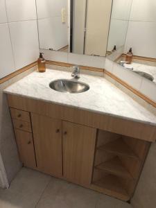 a bathroom with a sink and a mirror at Rolfi in Neuquén