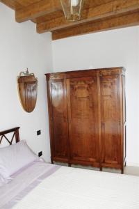 a bedroom with a bed and a dresser at La Filanda in Brescia