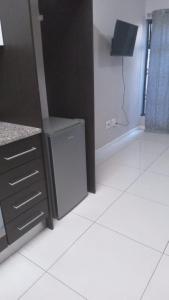 a kitchen with a washer and dryer in a room at Urban Studio Pvt Appartment in Durban