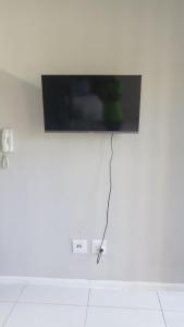 a flat screen tv hanging on a white wall at Urban Studio Pvt Appartment in Durban
