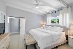 a white bedroom with a large bed and a window at Together but with Privacy 3 Units and Private Pool in Fort Lauderdale