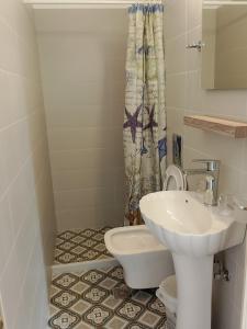 a bathroom with a sink and a toilet at LIGEIA HOME in Nafplio