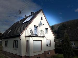 a white house with a black roof at FeWo Glücksmoment in Idar-Oberstein