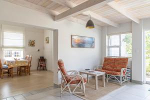 a living room with a table and chairs at Pianoforte holiday apartments in Swakopmund