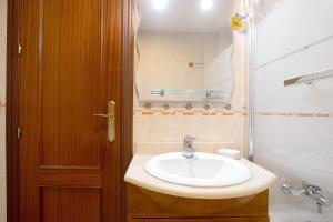 a bathroom with a sink and a mirror at La caleta in La Cala de Mijas +16 photos