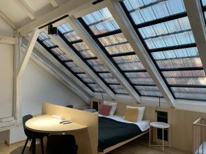 a bedroom with a bed in a room with skylights at Hotel Desatero in Mikulov