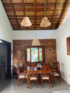 - une salle à manger avec une table et des chaises en bois dans l'établissement Sítio Valle do Sol, à Rio das Flores