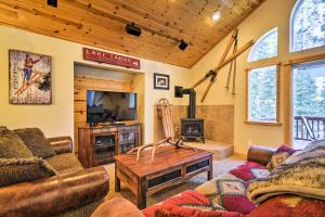 a living room with a couch and a table and a tv at Lake Tahoe Cabin with Private Beach Access in Tahoma