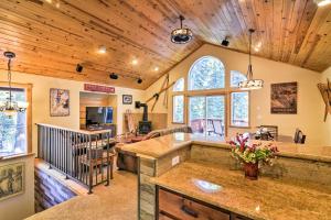 a kitchen and living room with wooden ceilings at Lake Tahoe Cabin with Private Beach Access in Tahoma