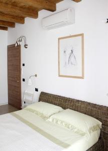 a bedroom with a bed and a picture on the wall at La Filanda in Brescia