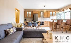a living room with a couch and a kitchen at Hermes luxury apartment in Vlachata village! in Vlachata +23 photos