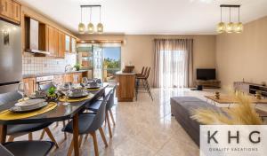 a kitchen and living room with a table and chairs at Hermes luxury apartment in Vlachata village! in Vlachata