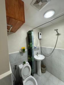 a bathroom with a toilet and a sink at LBS Condo Rental-Full Relaxing Seaview 304-10Flr in Lapu Lapu City