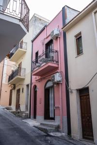 a row of colorful buildings in a street at Affittacamere Cecilia in Castellammare del Golfo