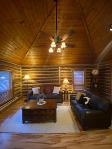 a living room with a couch and a ceiling fan at Erik's Ranch in Livingston