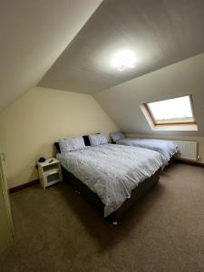 a attic bedroom with a bed and a window at Tewit Castle Adventures in Eryholme