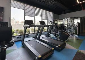 a gym with two treadmills and two laptops in it at OMO! Insane Deal! Studio near Me'aisem City Center in Dubai