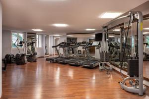 a gym with a bunch of treadmills and machines at UNA HOTELS Capotaormina in Taormina