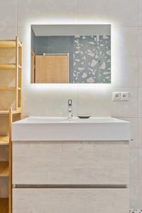 a bathroom with a white sink and a mirror at New Design Studio in Hollerich ID223 in Luxembourg