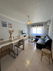 a living room with a couch and a table at APARTAMENTO Casa Hortense in Olhão