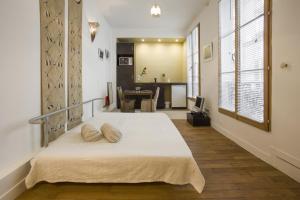 a bedroom with a bed with two pillows on it at Studio Beaune in Paris