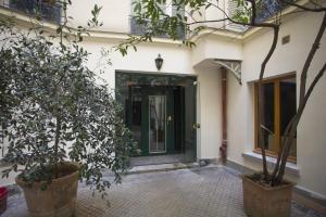 a door to a building with trees in front of it at Studio Beaune in Paris