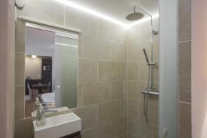 a bathroom with a shower and a sink and a mirror at Studio Beaune in Paris