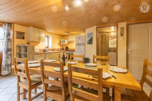 a kitchen and dining room with a wooden table and chairs at Gîte Le Tsozal in Aussois