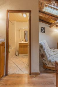 a room with a bed and a bathroom with a sink at Gîte Le Tsozal in Aussois +16 photos
