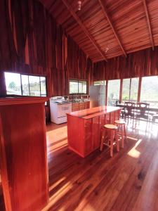 a kitchen with a counter and a table and chairs at My Country House Paradise, Rio Celeste! in San Rafael