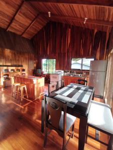 a kitchen with a table and chairs in a room at My Country House Paradise, Rio Celeste! in San Rafael