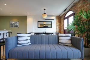 a blue couch in a living room with a table at Beautiful 2BR in Casco Viejo in Panama City