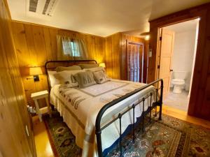 una camera da letto con un letto e un bagno di Little Red Wing 50s Lake Cabin a Bradford
