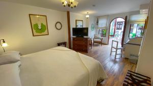 a bedroom with a bed and a television in it at Sakti Hostal B&B in Quito