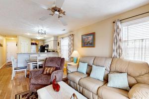 a living room with a couch and a table at River Oaks 10D in Myrtle Beach