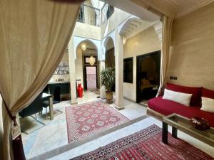 a bedroom with a bed and a living room at Riad ART DE VIVRE avec Jacuzzi in Marrakech +26 photos