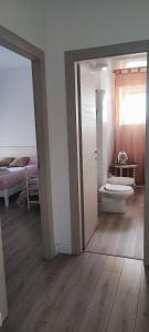 a room with a bathroom with a toilet and a bed at Casa Angelina in Rome