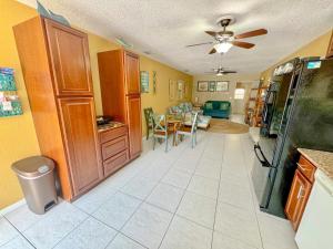 a kitchen and living room with a ceiling fan at Saltwater Retreat of Redington Shores in St. Pete Beach