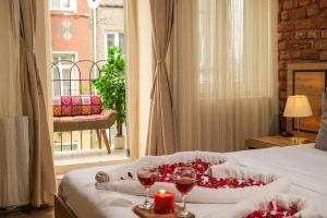 a bedroom with a bed with a candle and wine glasses at Taksim Nikea Suites 80 in Istanbul