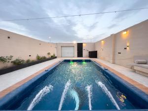 a swimming pool in the middle of a house at استراحة غزل in Medina