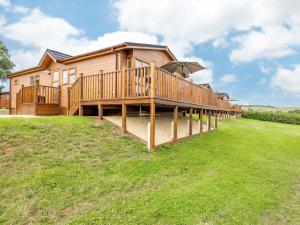 a large wooden house with a large deck at 2 Bed in Kinlet 92659 in Kinlet
