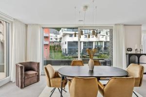 a living room with a table and chairs at Luxury 2BR, Free Parking, Balcony in Luxembourg