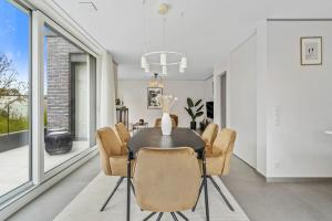 a dining room with a table and chairs at Luxury 2BR, Free Parking, Balcony in Luxembourg