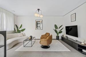 a living room with a couch and a chair at New High-End 2 BR Penthouse w Balcony in Luxembourg
