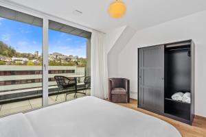 a bedroom with a large bed and a balcony at New High-End 2 BR Penthouse w Balcony in Luxembourg