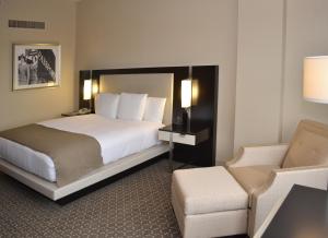 a hotel room with a bed and a chair at DoubleTree by Hilton Hotel Houston Hobby Airport in Houston