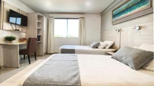Un ou plusieurs lits dans un hébergement de l'établissement Danieri Asunción Hotel