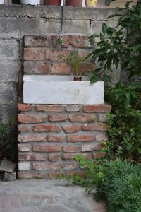 a brick wall with a planter on top of it at Studio 1 in Katerini in Katerini