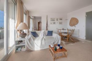 a bedroom with a bed and a table with a dining room at Superbe balcon - Vue mer - Appart pour 2 in La Baule +17 photos