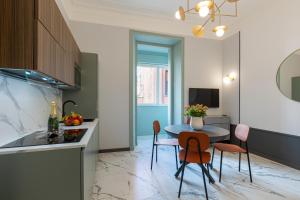 a kitchen and dining room with a table and chairs at The Romulus in Rome